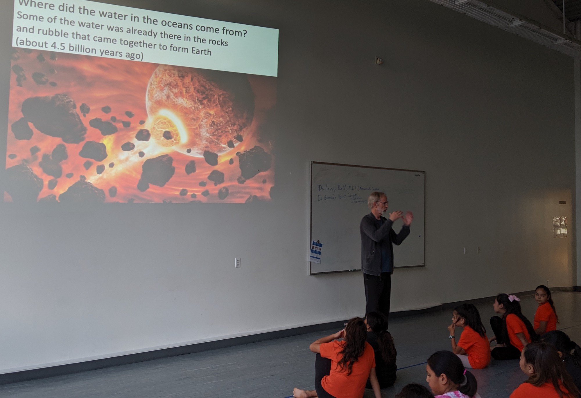 Larry Pratt explaining the origins of water on earth to the class.
